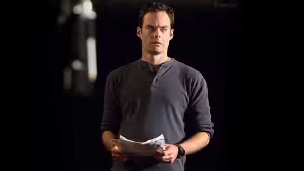 Barry Berkman (Bill Hader) stands in darkness holding papers
