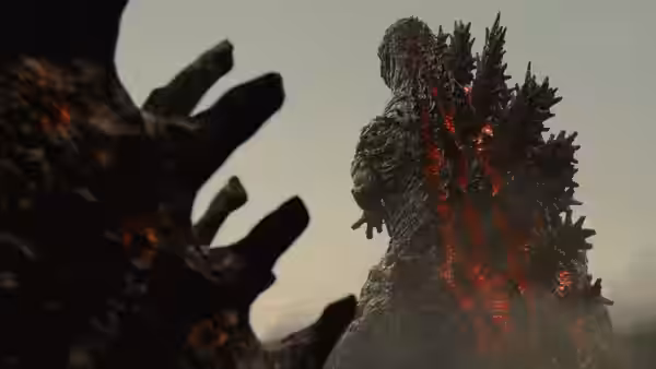 Godzilla towers against the sky, glowing fissures across its body