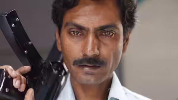 close-up of a man holding a rifle and looking ahead intently