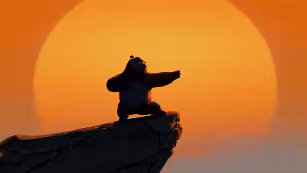 Po balances on a rocky outcrop, practicing a pose before the setting sun