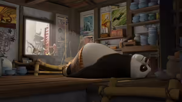 Po lies sprawled across a restaurant counter as activity continues outside