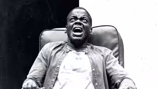 Chris (Daniel Kaluuya) strapped in a chair shouting with mouth open
