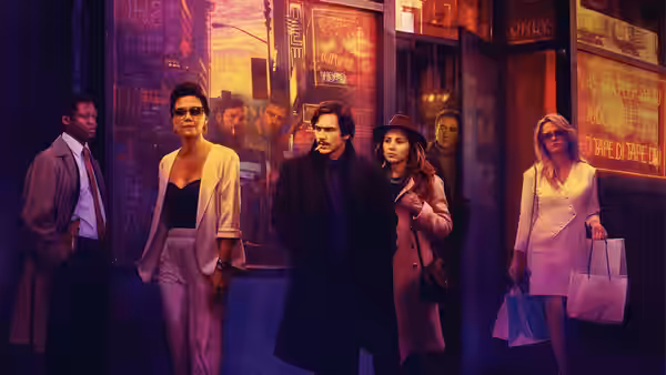 Group of men and women standing together on a sidewalk outside a building at night