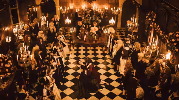 Courtiers in wigs and gowns gather on checkered floor beneath chandeliers