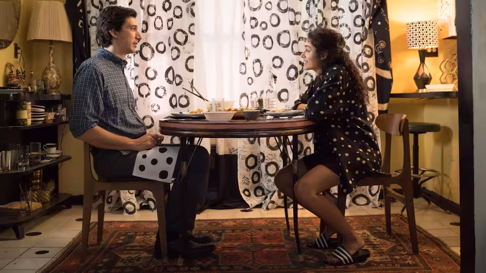 Paterson (Adam Driver) and Laura (Golshifteh Farahani) sit facing each other at a round table