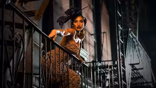 woman in brown dress and headpiece posing on outdoor fire escape at night
