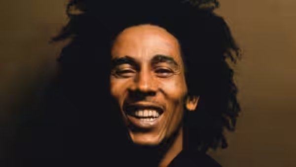 Bob Marley smiles against a dark background