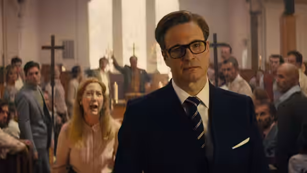 Harry Hart (Colin Firth) stands among churchgoers as a woman shouts behind him