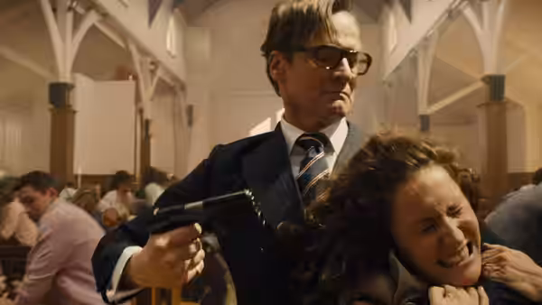 Harry Hart (Colin Firth) holds a woman at gunpoint inside a crowded church