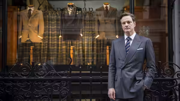 Harry Hart (Colin Firth) stands outside the Kingsman tailor shop