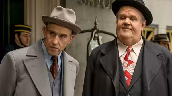 Stan Laurel (Steve Coogan) and Oliver Hardy (John C. Reilly) stand together on a city street