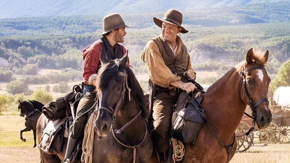 Charlie Sisters (Joaquin Phoenix) and Eli Sisters (John C. Reilly) ride horses across open country