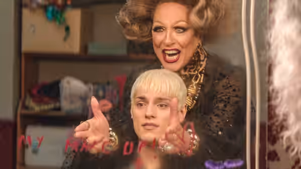Loco Chanelle (Richard E. Grant) helps Jamie New prepare in a dressing room