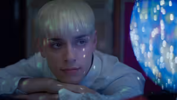 Jamie New (Max Harwood) rests beside a glowing disco light