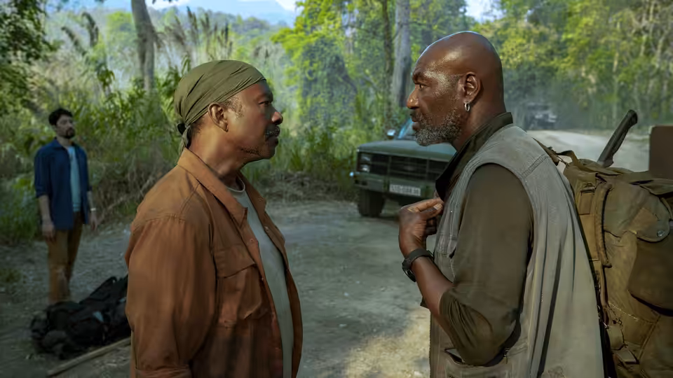 Paul (Delroy Lindo) faces Otis (Clarke Peters) beside a parked truck in the jungle