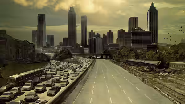 An empty highway clogged with abandoned vehicles leading into a ruined city