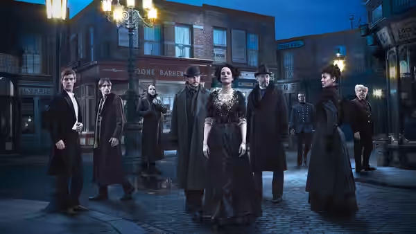 Vanessa Ives (Eva Green) stands among a group on a nighttime cobblestone street