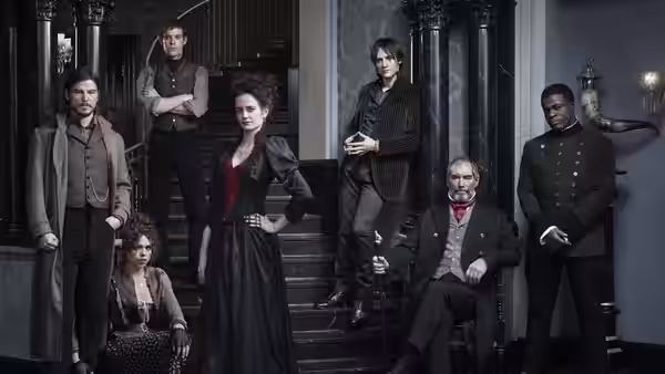 Vanessa Ives (Eva Green) poses with others on a grand staircase indoors