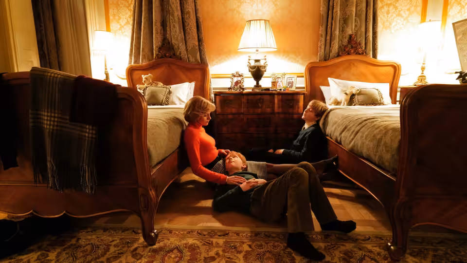 Diana (Kristen Stewart) sits on the floor between two beds with her sons