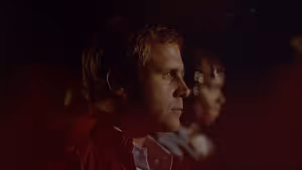 Tom Walsh (Gary Swanson) sits in a dark car, watching the road