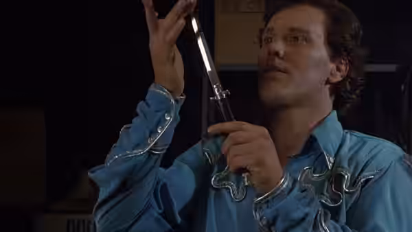 Ramrod (Wings Hauser) examines a knife in his hand
