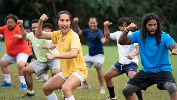 Jaiyah (Kaimana) leading an exercise group on the grass field