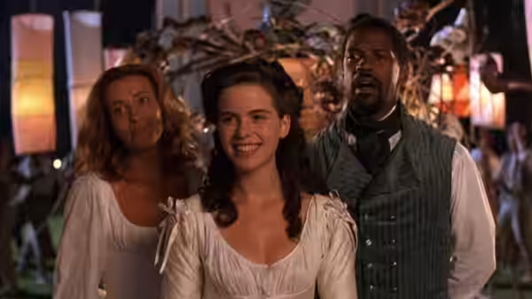 Hero (Kate Beckinsale) smiling beside Margaret and Don Pedro at night
