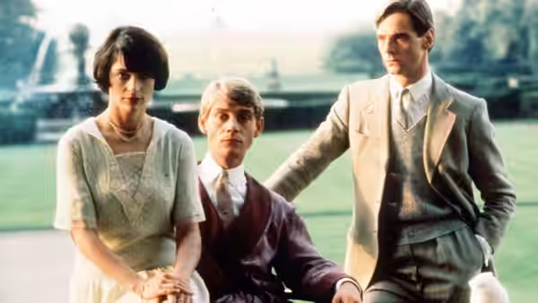 Lady Julia Flyte (Diana Quick) standing with two young men on a lawn near a fountain