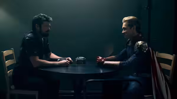 Billy Butcher and Homelander seated across a table in dim light