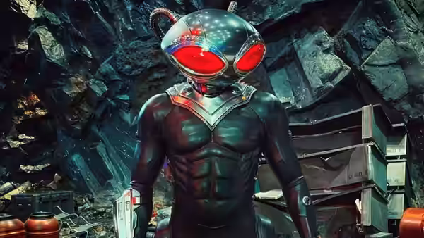 Black Manta (Yahya Abdul-Mateen II) standing in a rocky cavern