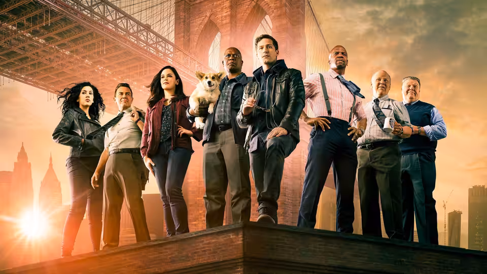 A group of detectives poses on a rooftop ledge with the Brooklyn Bridge behind