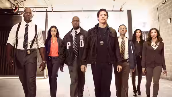 A team of detectives walks through a bright indoor hallway