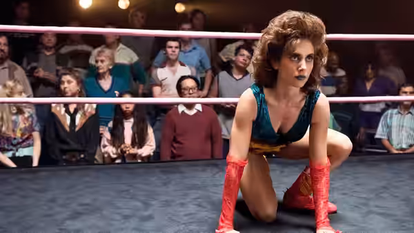 Ruth Wilder (Alison Brie) crouches in a wrestling ring before spectators