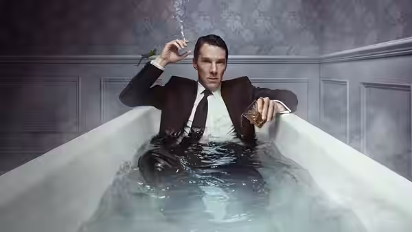 Patrick Melrose (Benedict Cumberbatch) sitting in a bathtub holding a cigarette and drink