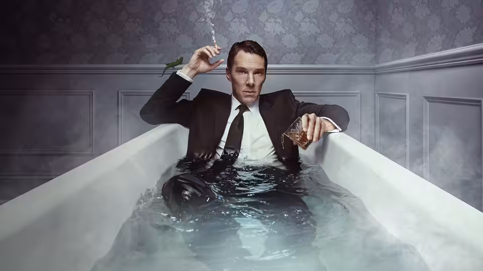 Patrick Melrose (Benedict Cumberbatch) sitting in a bathtub holding a cigarette and drink