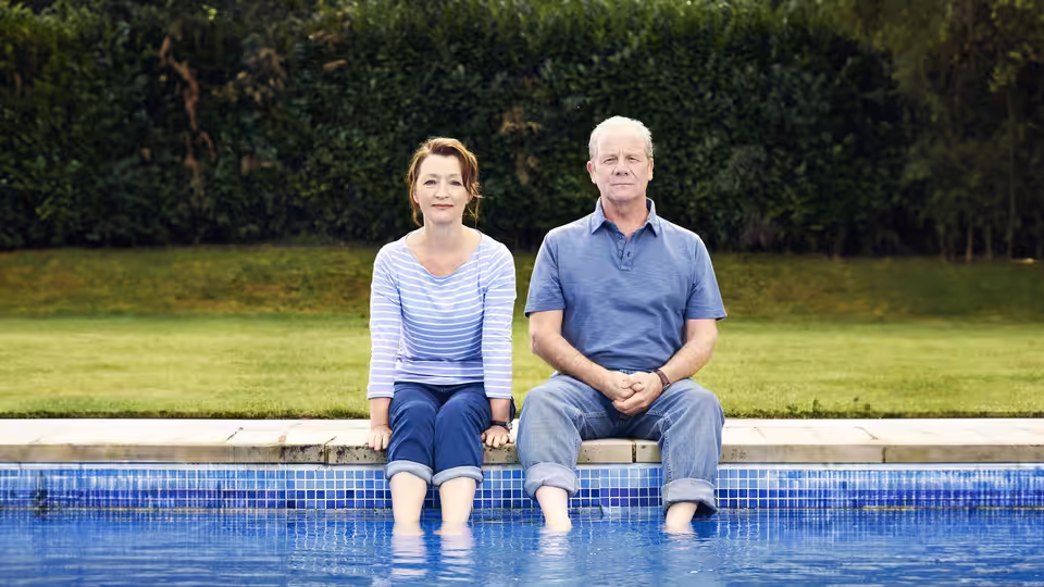 Cathy (Lesley Manville) and Michael (Peter Mullan) sitting by the pool