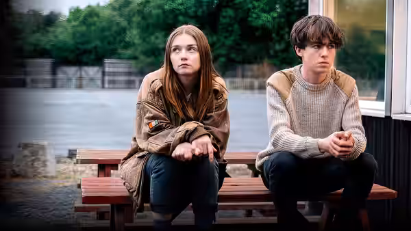 Alyssa (Jessica Barden) and James (Alex Lawther) sit on a bench looking ahead with worried expressions
