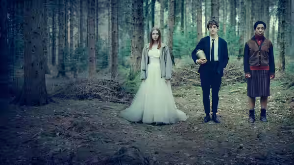 Alyssa (Jessica Barden) in a wedding dress stands in a forest beside James (Alex Lawther) holding a bowling pin and another girl