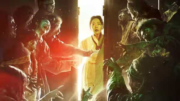 Woman in pale robe stands in bright doorway as zombies reach toward her