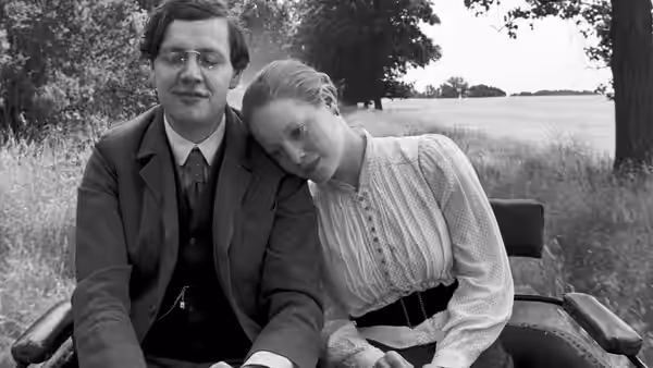 the school teacher (Christian Friedel) and Eva (Leonie Benesch) in a field