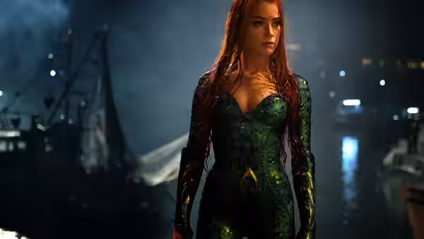 Mera stands on a wet dock at night