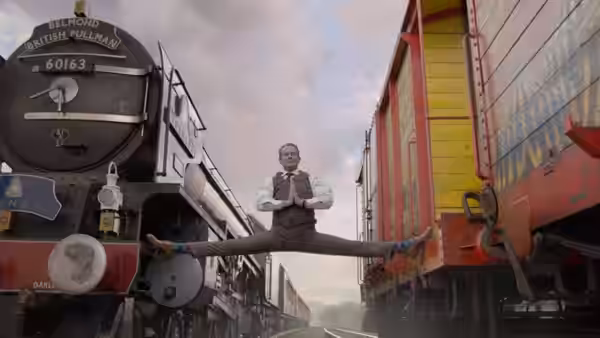 Phoenix Buchanan (Hugh Grant) performs splits between two trains