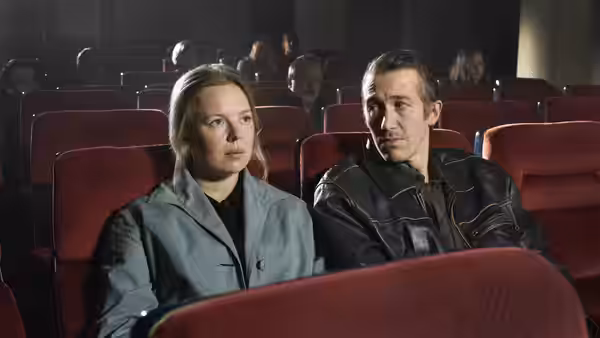 Ansa and Holappa seated side by side in a red cinema auditorium