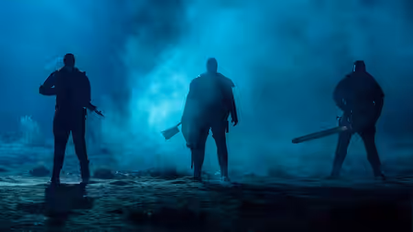 three armed figures standing in blue smoke on open ground
