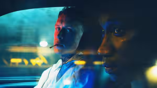 Preston (George MacKay) with a cigarette and Jules (Nathan Stewart-Jarrett) in a car