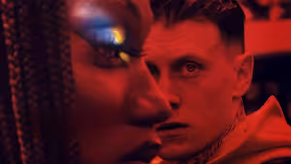 Jules (Nathan Stewart-Jarrett) and Preston (George MacKay) in close-up under red light