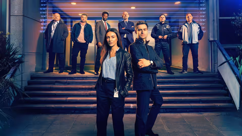 DI Emma Crane (Michelle Keegan) and DI Tom Radley (Douglas Booth) stand before their team on building steps