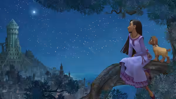 Asha (Ariana DeBose) sits on a tree branch with a goat overlooking a town at night