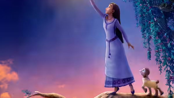 Asha (Ariana DeBose) reaches upward on a branch beside a goat under a starry sky