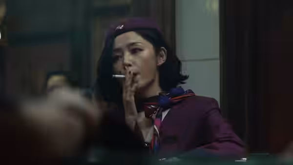 A woman in purple uniform and beret smoking a cigarette indoors